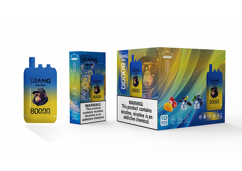 A Colorful Packaging Of The Bang Vape, Featuring A Cartoon Monkey Wearing Sunglasses, With Text Indicating It Delivers 80,000 Puffs And Flavors Including Blueberry Ice, Black Orange Ice, And Mango Peach, Alongside A Warning About Nicotine.