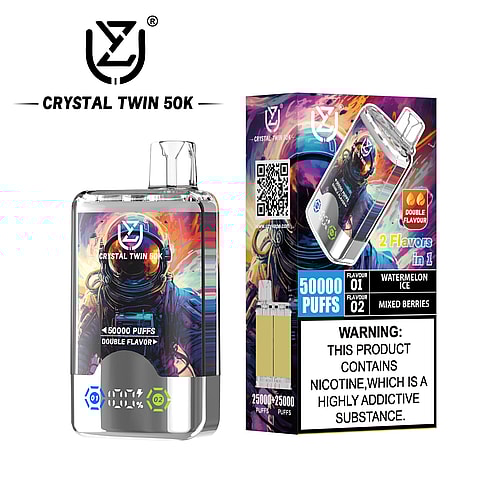 A Crystal Twin 50K vape device is featured alongside its bright packaging, showcasing a visually striking astronaut graphic and labels indicating it can deliver 50,000 puffs with double flavors of Watermelon Ice and Mixed Berries, and includes a warning about nicotine addiction.
